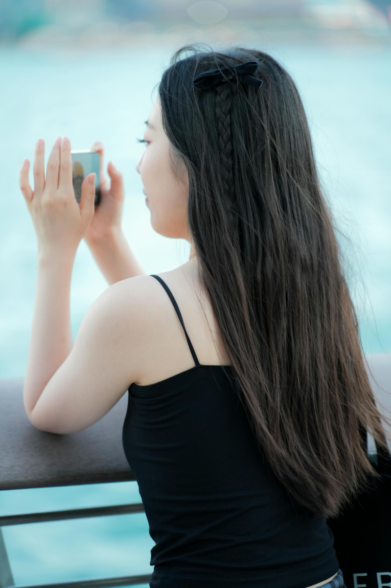 Photo by tslui: https://www.pexels.com/photo/young-woman-photographing-scenic-waterfront-view-34068955/