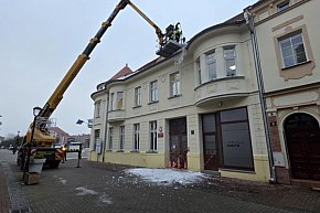 Usuwanie śniegu z dachu miejskiej kamienicy w Gostyniu-13631